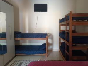 a room with two bunk beds and a television at Espaço Dtalia in Piedade +19 photos