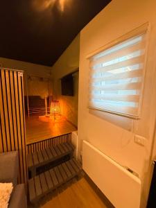 a room with a balcony with a window with a table at Au bât Tournai chambre zen in Tournai +1 photo