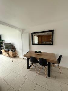 a dining room with a table and two chairs at Tomorrowland Home in Boom