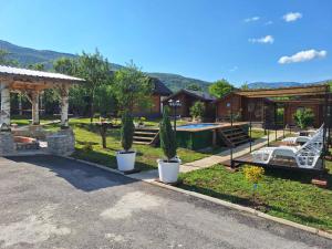 a house with a swimming pool and a yard with cactus at SkyFrame cottage with pool in Plav
