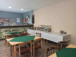 a restaurant with tables and chairs and a counter at Penzion Athena in Velenov