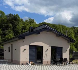 a house with a black roof and a patio at Villa Lux Una in Bosanska Krupa