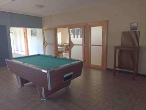 a room with a pool table on a tile floor at Penzion Athena in Velenov