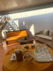 a living room with a table and a couch at Baia Marina Oasi in Balestrate