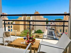a table on a balcony with a view of a city at Horizon Santa Monica in Aguadulce