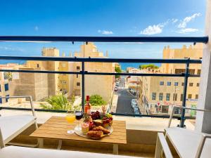 a table with food and drinks on a balcony at Horizon Santa Monica in Aguadulce