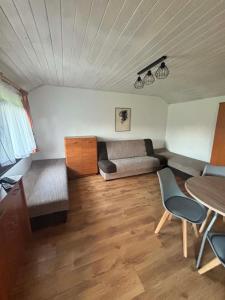 a living room with a couch and a table at Domki letniskowe u Marty in Łeba