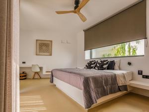 a bedroom with a bed and a large window at Skylines Estate Paros in Kampos Paros +117 photos