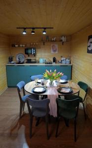 a dining room with a table and chairs and a kitchen at The Doma in Oral +35 photos