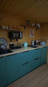 a kitchen with blue cabinets and a counter top at The Doma in Oral