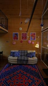 a living room with a couch and a rug at The Doma in Oral