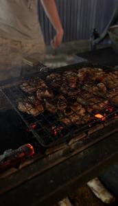 a bunch of meat cooking on a grill at The Doma in Oral