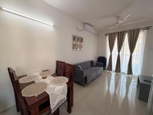 a living room with a table and a couch at Jula Hearth 1BHK in Chicalim