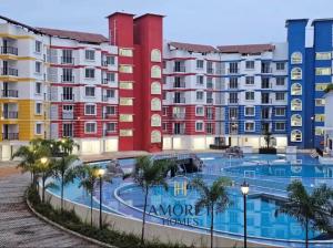 a row of apartment buildings with a swimming pool at Jula Hearth 1BHK in Chicalim