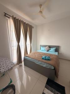 a bedroom with a bed and a window at Jula Hearth 1BHK in Chicalim +7 photos