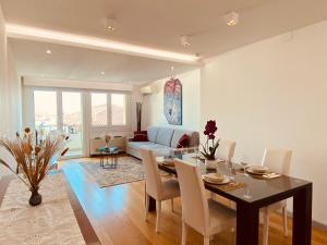 a dining room and living room with a table and chairs at Anna's Cozy Nest a Udine in Udine