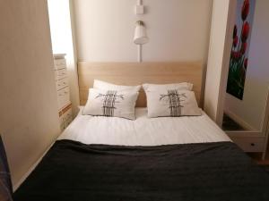 a bedroom with a bed with two white pillows at Cosy studio-apartment in the centre of Hudksvall #5 in Hudiksvall