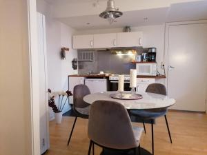 a kitchen and dining room with a table and chairs at Cosy studio-apartment in the centre of Hudksvall #5 in Hudiksvall
