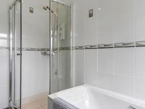 a white bathroom with a shower and a sink at Kents Bank Holiday - Pet Friendly with Bay Views in Grange Over Sands +81 photos