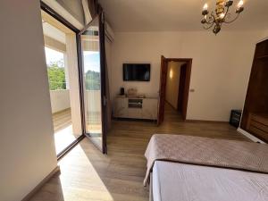 a bedroom with a bed and a sliding glass door at Chilometro Mille Suites e Apartments in Otranto