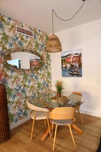 a dining room with a glass table and a mirror at Divi Apartments Costa Ballena in Costa Ballena