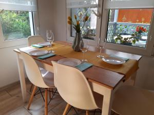 a dining room table with chairs and a table with wine glasses at Przystań Arizona Ostróda in Ostróda