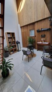 a large room with chairs and tables and a table at Au bât Tournai chambre zen in Tournai