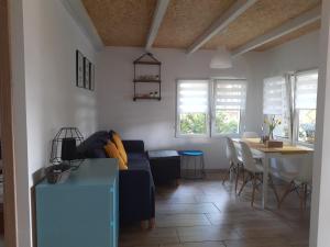 a living room with a couch and a table at Przystań Arizona Ostróda in Ostróda