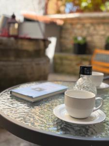 a cup of coffee and a book on a table at Apartment Marija in Vodnjan