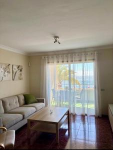a living room with a couch and a coffee table at Sueños de Tabaiba y Mar in Tabaiba