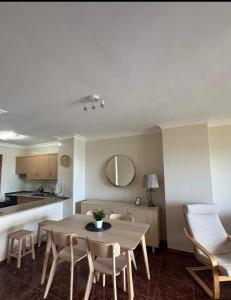 a kitchen and a dining room with a table and chairs at Sueños de Tabaiba y Mar in Tabaiba +36 photos