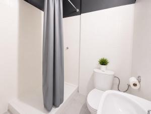 a bathroom with a toilet and a shower curtain at Grey Poznań Pokój z łazienką, Free Parking & Self Check-in in Poznań +67 photos