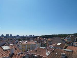 a view of roofs of buildings in a city at Estádio da Luz Room in Lisbon