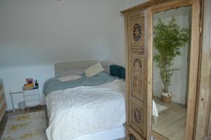 a bedroom with a wooden bed with a mirror at maison pour vieilles charrues in Maël-Carhaix