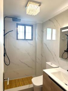 a bathroom with a shower and a toilet and a sink at Cute get away apartment RBLD in La Mata