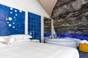 a bedroom with a bed and a bath tub at Le Suite dei Pescatori in Praiano +52 photos
