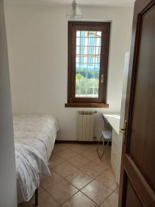 a bedroom with a bed and a window and a desk at Residence agli Oleandri in Manerba del Garda +14 photos