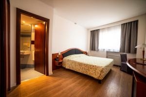 a hotel room with a bed and a bathroom at Hotel Donizetti in Lallio +39 photos
