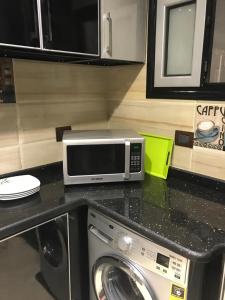 a microwave sitting on top of a kitchen counter at Alex dream in Alexandria +128 photos
