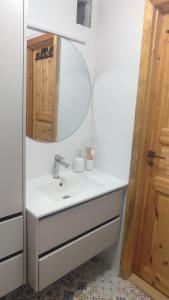 a bathroom with a sink and a mirror at Viļāni Nākotnes in Viļāni +7 photos