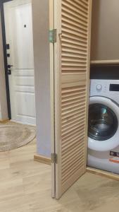 a door open to a laundry room with a washing machine at Viļāni Nākotnes in Viļāni