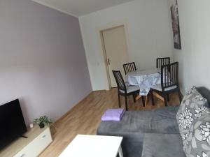a living room with a couch and a table at Apartment Zur Bauhütte, WLAN in Hohenstein-Ernstthal