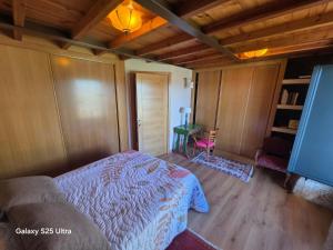 a bedroom with a bed and a table in it at La casa de arriba in Ourense