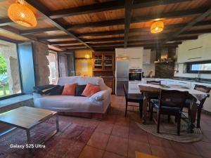 a living room with a couch and a table at La casa de arriba in Ourense