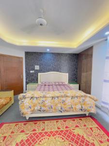 a bedroom with a large bed with a large rug at Stay lux yellow in Islamabad