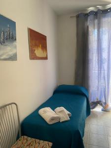 a room with a bed with two towels on it at Casa vacanza La Ninfea intera casa in Caltagirone +105 photos