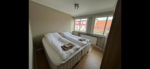 a small bedroom with a bed and a window at Apartment Bergen Central - private balcony in Bergen