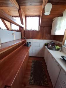 a kitchen with wooden cabinets and a counter top at U Cecylii in Rowy +6 photos