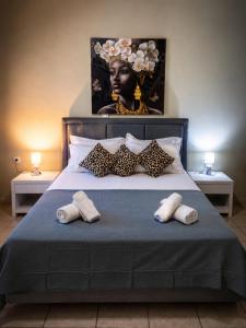 a bedroom with a large bed with a bust of a woman at Sunray Separate Villa in Skala Sotiros