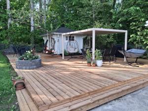 a wooden deck with a gazebo at Aittamajotus casinonsaari in Savonlinna